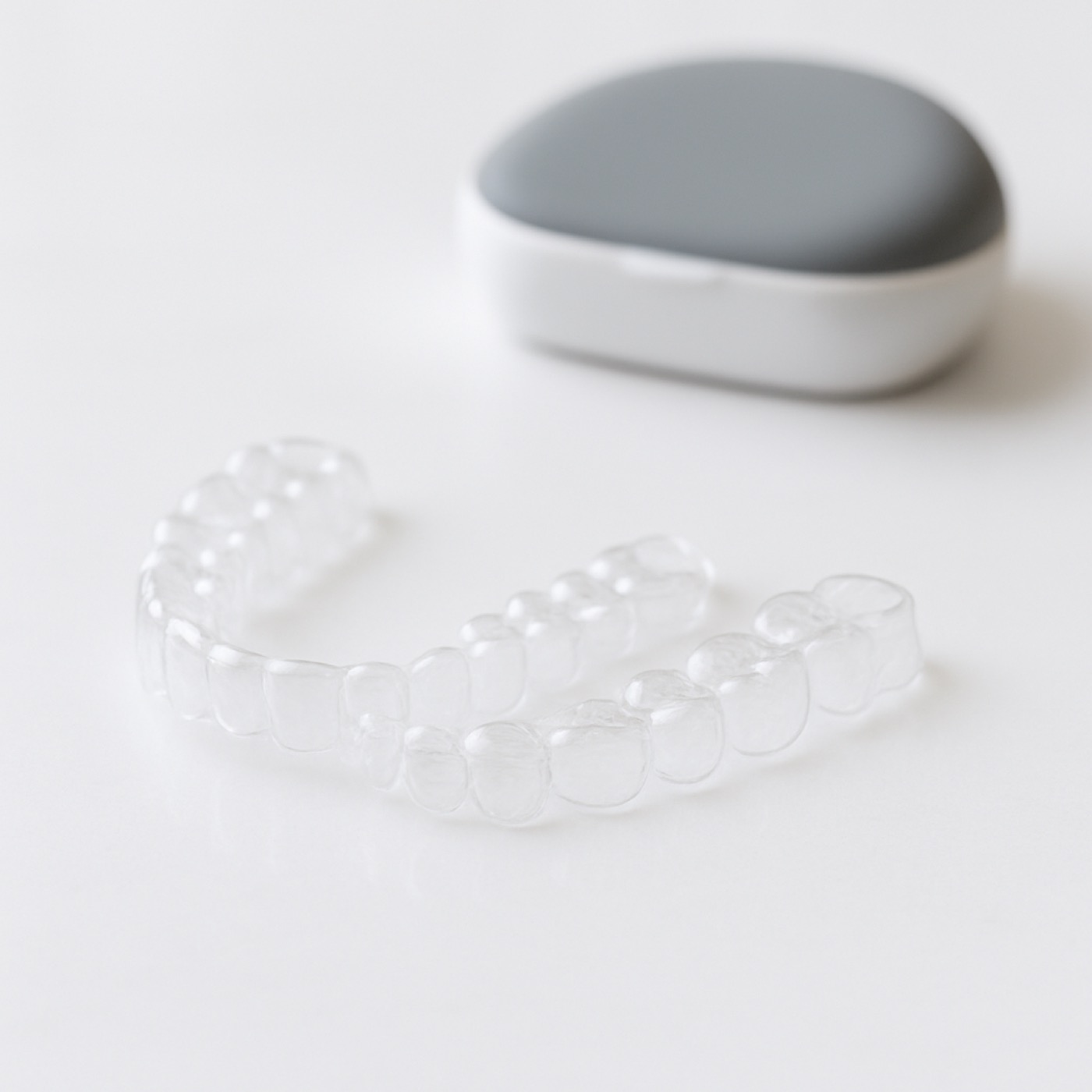 Woman smiling confidently wearing clear Invisalign aligners